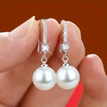 Pendientes colgantes de perla y circonitas | Oro blanco